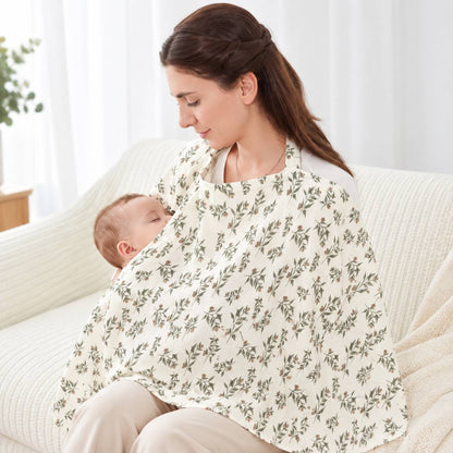 Cape d'allaitement à motif floral portée par une maman avec bébé à la maison