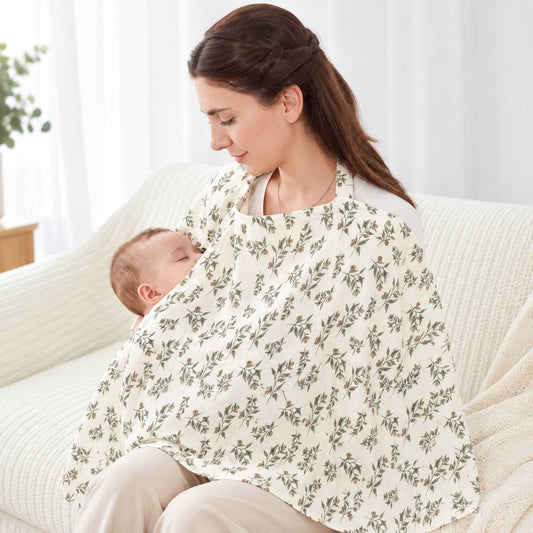 Cape d'allaitement à motif floral portée par une maman avec bébé à la maison